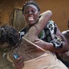 Dos mujeres se abrazan después de que un grupo armado incendiara una docena de casas en la aldea de Kibusu el 10 de enero.