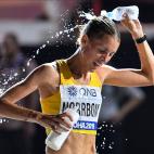 Cecilia Norrbom, of Sweden, pours water on herself during the women's marathon at the World Athletics Championships in Doha, Qatar, Saturday, Sept. 28, 2019. (AP Photo/Martin Meissner)