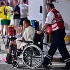 An unidentified competitor is transported by wheelchair after abandoning the women's marathon at the World Athletics Championships in Doha, Qatar, Saturday, Sept. 28, 2019. (AP Photo/Martin Meissner)