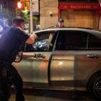Police stop a driver in the SoHo shopping district Sunday, May 31, 2020, in New York. Protests were held throughout the city over the death of George Floyd, who died May 25 after he was pinned at the neck by a Minneapolis police officer. (AP Pho...