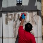 EDITORS NOTE: Graphic content / A worker removes graffiti near the White House after a third night of violent protests over the death of George Floyd June 1, 2020, in Washington, DC. - Police fired tear gas outside the White House late Sunday as...