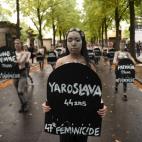 Femen activists hold placards shaped as tombstones, reading the name and the age of each women killed this year by their partner in 2019, during a protest action dedicated to the memory of the women killed by their partner or ex-partner and agai...