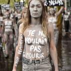 Leader of the feminist activist group Femen Inna Shevchenko (front) and Femen activists hold placards reading "More heard dead than alive", "I didn't want to die" during a protest action dedicated to the memory of the women killed by their partn...