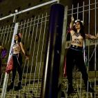 Activists of women's rights organisation Femen, are chained to the gate of Palacio Vistalegre, with the words "against fascist vote" painted on their body, early on October 6, 2019 in Madrid, during a protest against a campaign rally of Spanish ...