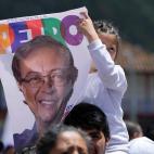 A girl holds a poster of Historical Pact coalition presidential candidate Gustavo Petro, during a closing campaign rally in Zipaquira, Colombia, Sunday, May 22, 2022. Elections are set for May 29. (AP Photo/Fernando Vergara)