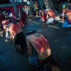 Devotos católicos rezan arrodillados tras flagelarse con motivo de la Semana Santa en Mabalacat (Filipinas). Aunque este acto está condenado por la Iglesia Católica, miles de filipinos siguen siendo fieles a esta práctica.