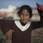 In Saturday, April 5, 2014 photo, Dalal Hussain, 10, poses for a portrait in an unofficial Syrian refugee camp on the outskirts of Amman, Jordan. More than 2.8 million Syrian children inside and outside the country _ nearly half the school-aged ...