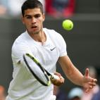 Carlos Alcaraz hits a return during the men's singles third round match between Carlos Alcaraz of Spain and Oscar Otte of Germany at Wimbledon Tennis Championship in London, Britain, on July 1, 2022. (Photo by Han Yan/Xinhua via Getty Images)