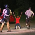 La policía detiene a dos personas en un coche en las manifestaciones del 13 de agosto en Ferguson (Misuri). 