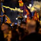 A protestor burns a flare as a pro-independence Estelada flag is waved in Puerta del Sol square in Madrid, Spain, Wednesday, Oct. 16, 2019. Spain's government said Wednesday it would do whatever it takes to stamp out violence in Catalonia, where...