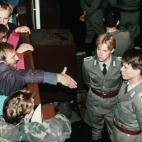 Soldados del este, unas horas después de la caída del muro, eludiendo dar la mano a un berlinés. 