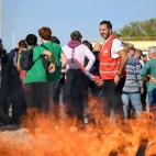 Workers and CGT unionists gather at the entrance of Total Energies refinery in La Mede, southern France, on October 11, 2022. - Around a third of France's service stations were still low on, or out of, petrol as strike action at energy giant Tot...