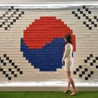A woman looks at the South Korean flag made with messages supporting South Korea's national football team at the Korea House in Foz do Iguacu, Parana, on June 13, 2014 during the 2014 FIFA World Cup in Brazil. (JUNG YEON-JE/AFP/Getty Images)