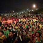 People watch on a huge screen the Brazil vs Croatia opening match during the FIFA Fan Fest in Copacabana Beach in Rio de Janeiro, Brazil on June 12, 2014. Brazil's ambivalence toward the World Cup was on full display as the country geared up for...