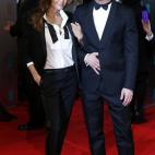 US actor Brad Pitt (R) and his wife Angelina Jolie arrive on the red carpet for the BAFTA British Academy Film Awards at the Royal Opera House in London on February 16, 2014. AFP PHOTO / ANDREW COWIE (Photo credit should read ANDREW COWIE...