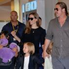US film stars Brad Pitt (R) and Angelina Jolie (back C), accompanied by their children, arrive at Haneda International Airport in Tokyo on July 28, 2013. Pitt is now here for the promotion of his latest movie 'World War Z'. AFP PHOTO / Yosh...