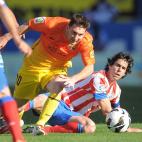 MADRID, SPAIN - MAY 12: Lionel Messi (L) of FC Barcelona gets past Tiago Cardoso Mendez of Club Atletico de Madrid during the La Liga match between Club Atletico de Madrid and FC Barcelona at Vicente Calderon Stadium on May 12, 2013 in Madrid,...