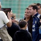 Argentina's forward Lionel Messi (C) poses for pictures with supporters during a training session in Ezeiza, Buenos Aires on March 19, 2013 ahead of the Brazil 2014 FIFA World Cup South American qualifier football match against Venezuela on Marc...
