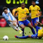 Argentinian soccer player Lionel Messi is tackled by Brazil's Danilo (R) as Juan (C) and Casemiro look on during a friendly match at MetLife Stadium in East Rutherford, New Jersey, on June 9, 2012. Argentina won 4-3. AFP PHOTO/Mehdi Taamallah...
