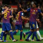 Barcelona's Argentinian forward Lionel Messi (L) celebrates with teammates after scoring during the Spanish League football match Barcelona vs Malaga at the Camp Nou stadium in Barcelona on May 2, 2012. AFP PHOTO / LLUIS GENE (Photo cred...