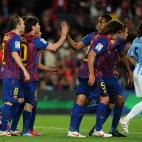 Barcelona's Argentinian forward Lionel Messi (2L) celebrates with teammates after scoring during the Spanish League football match Barcelona vs Malaga at the Camp Nou stadium in Barcelona on May 2, 2012. AFP PHOTO / LLUIS GENE (Photo cre...