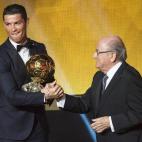 El delantero portugués del Real Madrid, Cristiano Ronaldo, recibe su tercer Balón de Oro de manos del presidente de la FIFA, Joseph Blatter