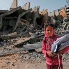 Una ni&ntilde;a de Gaza, que ha logrado salvar algunos de sus apuntes y libros del colegio tras los bombardeos de Israel.