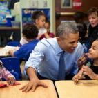 President Barack Obama gestures as he talks with Akira Cooper at the Community Children's Center, one of the nation's oldest Head Start providers, in Lawrence, Kan., Jan. 22, 2015. (Official White House Photo by Pete Souza)