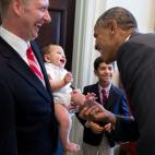 President Barack Obama greets the family of departing staff member Archana Snyder, Council of Economic Advisers, in the Outer Oval Office, July 3, 2014.