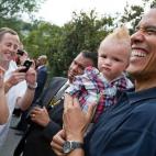 President Barack Obama holds a baby while greeting guests during an Independence Day celebration on the South Lawn of the White House, July 4, 2012. (Official White House Photo by Pete Souza)