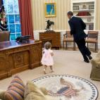 President Barack Obama runs around his desk in the Oval Office with Sarah Froman, daughter of Nancy Goodman and Mike Froman, Deputy National Security Advisor for International Economics, July 9, 2012. (Official White House Photo by Pete Souza)