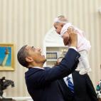 President Barack Obama holds up four-month-old Alia Jawando as her father, William Jawando, Deputy Associate Director of Public Engagement, and her mother Michele look on in the Oval Office, March 9, 2011. (Official White House Photo by Pete Souza)