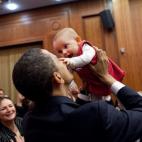 President Obama lifts up a baby April 4, 2009, during the U.S. Embassy greeting at a Prague hotel. (Official White House Photo by Pete Souza)