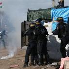 CALAIS, FRANCE - FEBRUARY 29: Police officers confront migrants and activists as part of the 'jungle' migrant camp is cleared on February 29, 2016 in Calais, France The French authorities have begun dismantling part of the migrant encampment i...