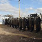 Anti-riot policemen face migrants and refugees (unseen) on February 29, 2016, during the dismantling of half of the 'Jungle' migrant camp in the French northern port city of Calais. Two bulldozers and around 20 workers began destroying makeshift...