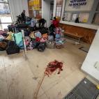 EDITORS NOTE: Graphic content / Evacuees sit near luggage in the train station hall in Kramatorsk, eastern Ukraine, on April 8, 2022, after a rocket attack. - A rocket attack on a train station in the eastern Ukrainian city of Kramatorsk killed ...