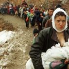 Una mujer albanesa da el pecho a su bebé mientras huye con otros 2.000 refugiados de la guerra de Kosovo en 1999.
