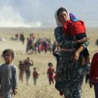 Desplazados de la minoría Yazidi huyen de las fuerzas del Estado Islámico por la frontera de Siria en agosto de 2014.
