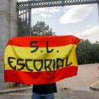 SAN LORENZO DEL ESCORIAL, SPAIN - OCTOBER 11: A person is seen holding a spanish flag at the 'Valle de los Caidos', after the announcement of the Government that the remains of dictator Francisco Franco will leave the basilica before 25th Octobe...