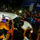 Soccer fans surround the hearse carrying the coffin of Diego Maradona to a funeral house in Buenos Aires, Argentina, Wednesday, Nov. 25, 2020. The Argentine soccer great who was among the best players ever and who led his country to the 1986 Wor...