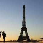 Una pareja baila con la puesta de sol de fondo el 6 de octubre en la plaza de Trocadero, frente a la Torre Eiffel en París.