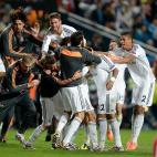 Real Madrid's Marcelo is mobbed by his team-mates after scoring his side's third goal
