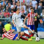 Real Madrid's Angel di Maria is fouled by Atletico Madrid's Raul Garcia