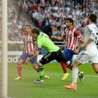 Real Madrid goalkeeper Iker Casillas scrambles in vain as Atletico Madrid's Diego Godin scores his side's first goal