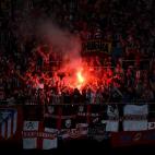 Atletico Madrid fans show their support with red flares in the stands