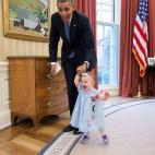 Obama walks with Lincoln Rose Pierce Smith, the daughter of former Deputy Press Secretary Jamie Smith, in the Oval Office on April 4, 2014.