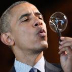 Obama blows a bubble from a bubble wand made with a 3D printer by 9-year old Jacob Leggette while touring exhibits at the White House Science Fair on April 13, 2016, in Washington, DC..