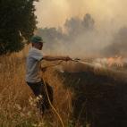 Un hombre combate las llamas el lunes con una manguera en Castanheira de Pera.