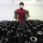 Una empleada detrás de unas botellas en una bodega de vinos en Tbilisi el 11 de febrero de 2013. (VANO SHLAMOV/AFP/Getty Images)