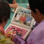 La surcoreana Han Shin-ja (izquierda), de 99 a&ntilde;os, y su hija la norcoreana Kim Kyung-yeong, de 71 a&ntilde;os, mirando fotos familiares.